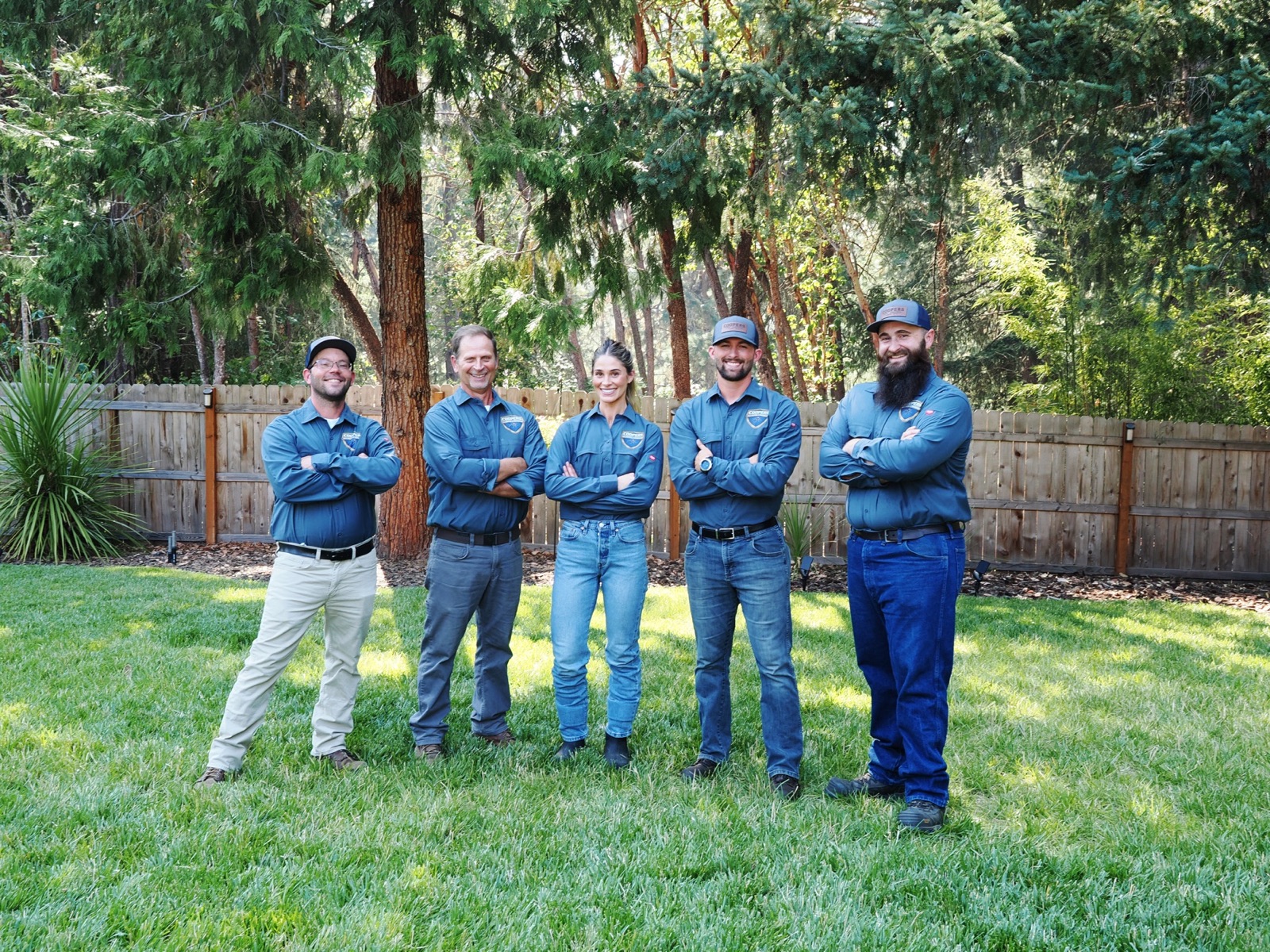 Cooper's Pest Control team standing together outdoors in company uniforms